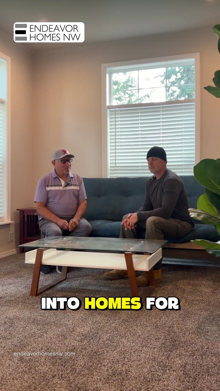 Two speakers seated together inside a home